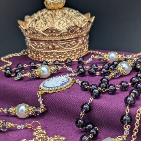 Blessed Mother purple pearl rosary with crucifix displayed, a devotional piece for learning how to pray the rosary