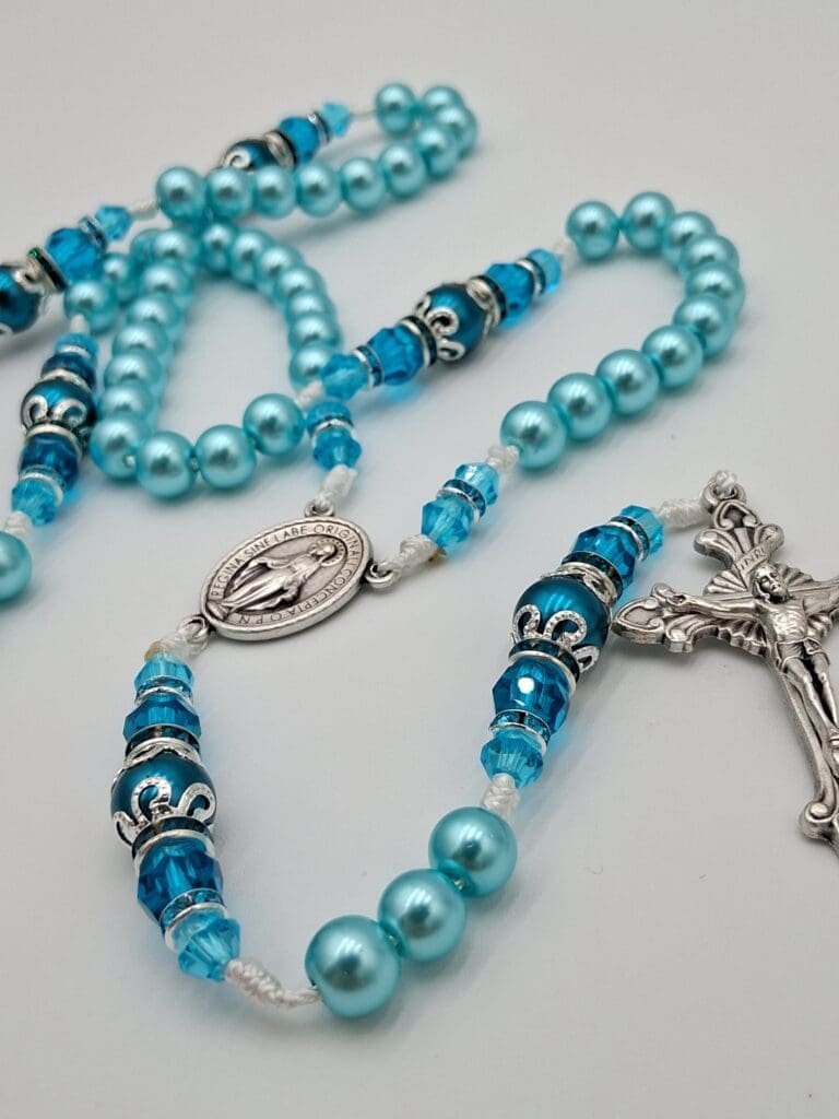 hands holding a rosary for baptism with soft natural light, emphasizing tradition and spiritual connection